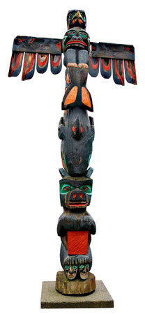 Painted totem pole of wealth in downtown Duncan British Columbia isolated on white