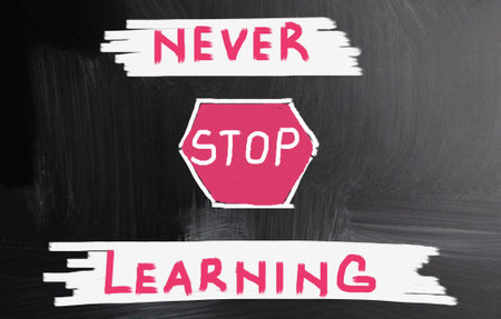 Bright motivational composition on the blackboard "Never stop learning"の写真素材