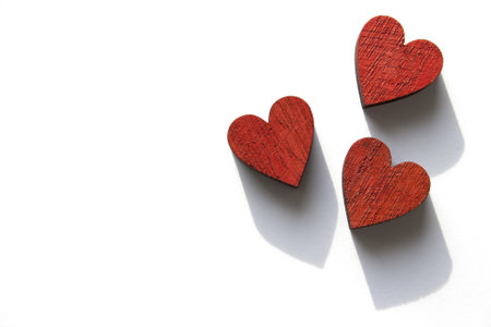 A top view shot of wooden red hearts isolated on a white backgroundの写真素材