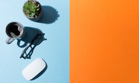 A work table with blue and orange background, copy spacesの写真素材