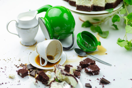 Mess on the table with cake in the backgroundの写真素材