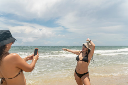 Girl posing at a photo shoot on the beachの写真素材