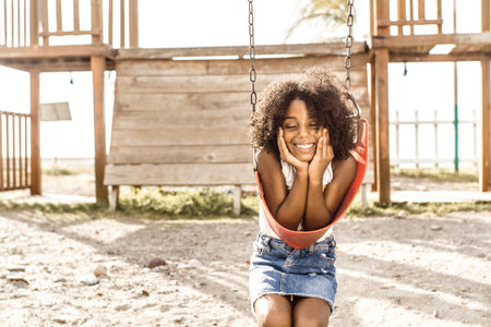 portrait of a smiling afro american girl look at camera. childhood and happiness concept.の写真素材