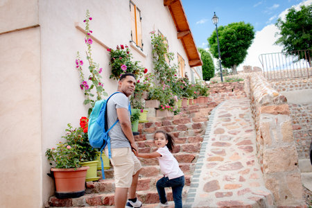 A girl with her vacation dad in the village of Perreux, France