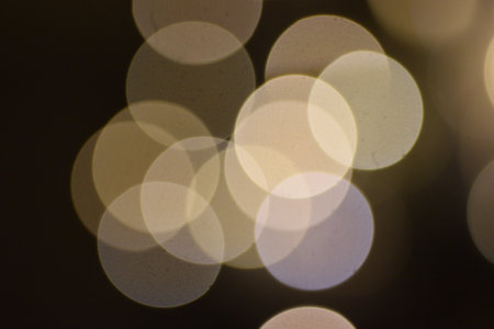 many bright blurry circles overlapping against dark background, design element