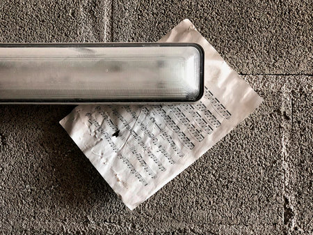 lamp and score on concrete brick wall. Still life