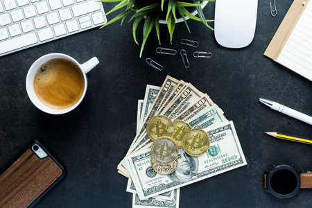 Flat lay top view office desk, bitcoin and dollars money