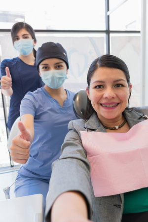Young woman reviewing her dental procedure. Very happy with how I am with all the change made to her...