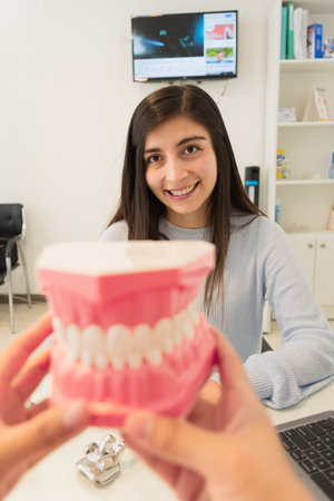 Young woman in a dental office, receiving advice from a dentist.の写真素材