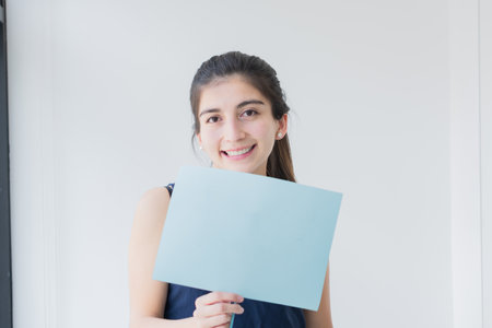 Very happy young woman with poster in hand. Showing your approval and support for the issue.の写真素材