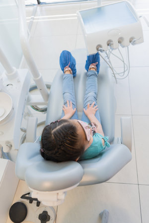 Little girl waiting in a dental office to receive her dental and braces treatment and care.の写真素材
