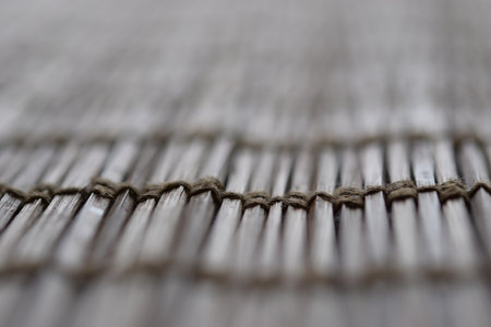 closeup of placemat made of woven bamboo sticks, as background with copy space
