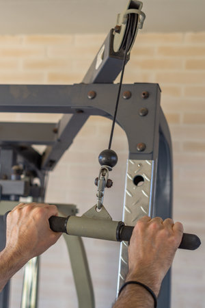 man's hands training with weights in the gymnasium