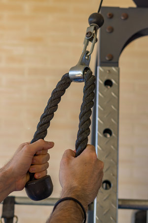 man's hands training with weights in the gymnasium