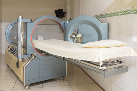 Hyperbaric treatment machine with a stretcher in a clinic
