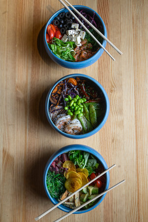 The Poke bowl is the latest trend in the food industry, a bowl with vegetables and salmon on a wooden backgroundの写真素材