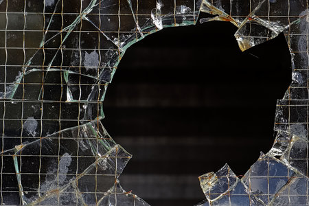 Closeup of a hole in a wired glass pane.の写真素材