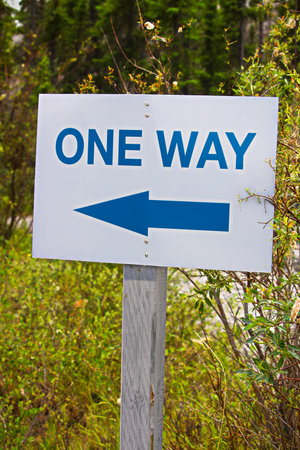 A one way sign with an direction arrow.の写真素材