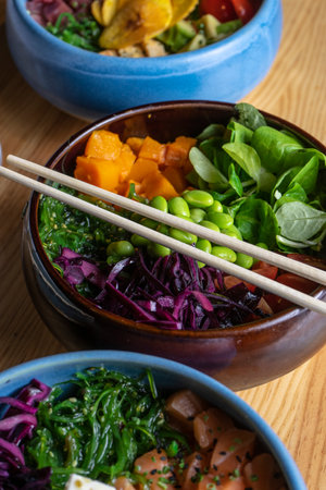 Vegan bowl with pumpkin, rice, wakame, edamame, red cabbage and lamb's lettuce in a bowl. Hawaiian poke bowl.の写真素材