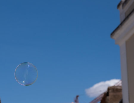 Soap bubble flying into the blue sky. Game, freedom, conceptの写真素材