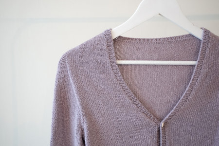 Close-up of purple cardigan on the hangerの写真素材