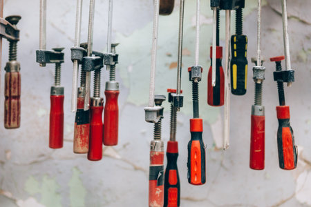 Bunch of manual limes hanging in carpenter workshop studioの写真素材