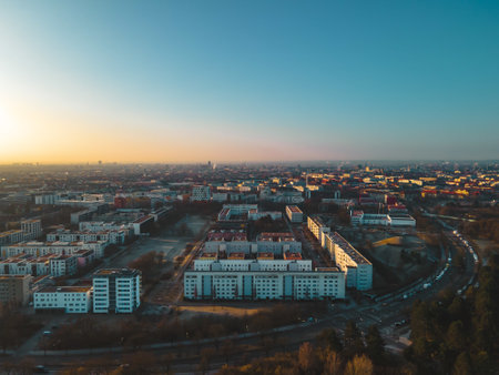 Aerial view of the city of Munich from Olympic Park. Drone flies over silhouette and houses of the city in the morning during sunriseのeditorial素材