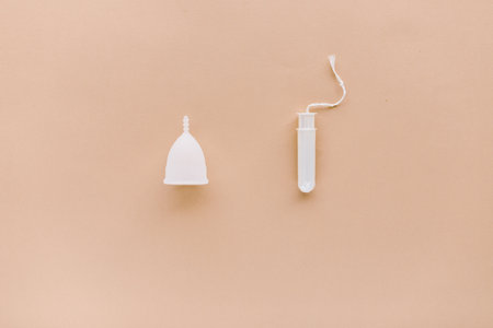 menstrual cup and a tampon on a  peach backgroundの写真素材
