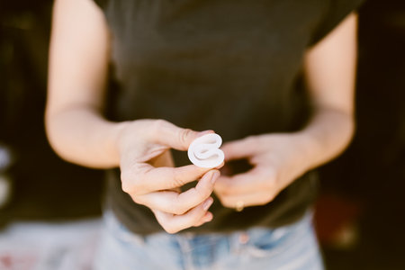 woman holding a folded menstrual cupの写真素材