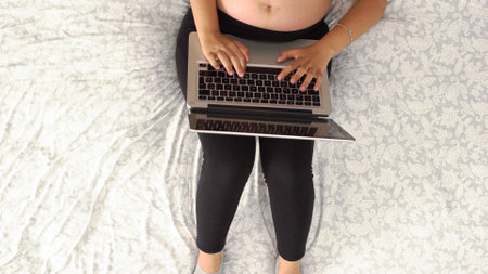 cenital view of a young woman working on laptop