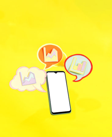 Smart phone and dialogue bubble with financial statistics. Mobile phone with chart symbols.の写真素材