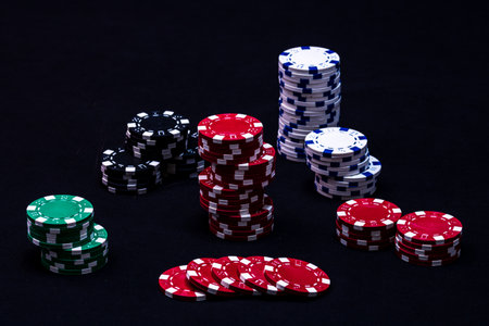 Stack of poker chips on black backgroundの写真素材