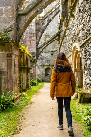 A young woman visiting the gardens inside the Abbaye de Beauport in the village of Paimpol, CÃ´tes-d'Armor department, French Brittany. Franceの写真素材
