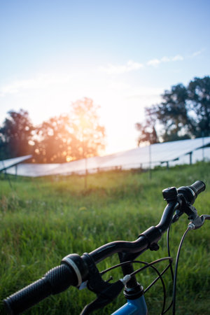 a bicycle in the solar farm for green energy.の写真素材