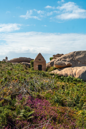 Old stone dwelling along Lighthouse Mean Ruz, port of Ploumanach, in the town of Perros-Guirec, Cotes-d'Armor, in French Brittany, France.の写真素材