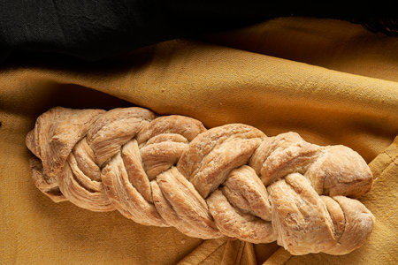 braided homemade bread on tablecloth