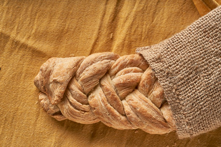 braided homemade bread on tableclothの写真素材