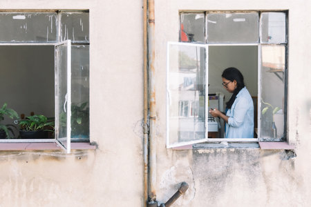 view of mexican housewife cooking through the windowの写真素材