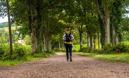A young mother with her baby in the Broceliande forest, a French mystical forest located in the Ille...