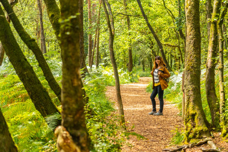 A young woman trekking on Lake Paimpont in the Broceliande forest, Ille-et-Vilaine department, Brittany, near Rennes. Franceの写真素材