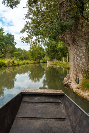 Sailing by boat on the natural water channels between La Garette and Coulon, Marais Poitevin the Green Venice, near the city of Niort, Franceの写真素材