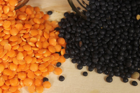 Black, Green and Orange Lentils on Wooden Tableの写真素材