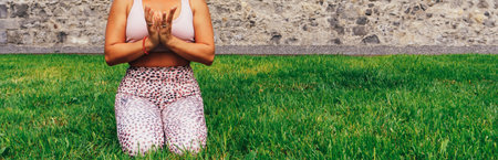 Young unrecognizable Caucasian yogi, performing yoga in a park. Copy spaceの写真素材