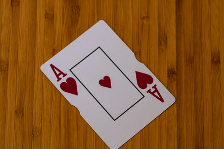 Detail of Ace of hearts card on wooden table