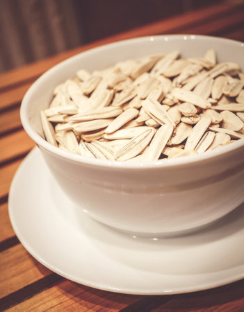 Sunflower seeds in a white bowlの写真素材