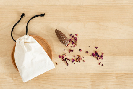 Small cloth gift bag, on wooden desk.の写真素材