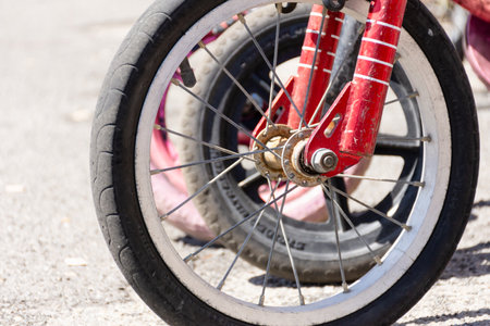 Close up of the fron wheel of a childs bicycleの写真素材