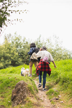 Young man walking with his pet through nature.の写真素材