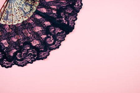 view of a beautiful floral hand fan on the pink surfaceの写真素材