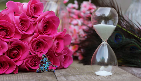 Vintage Hourglass With Pink Roses and Peacock Feathers
